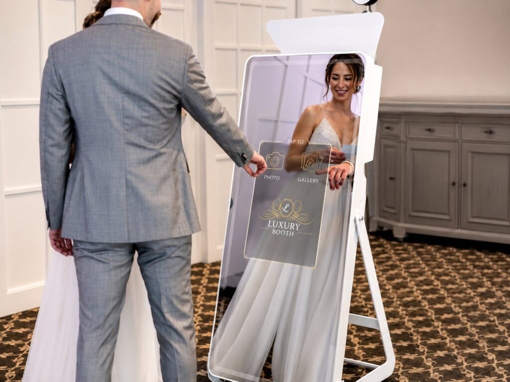 A bride and groom using a mirror photo booth together at their wedding reception